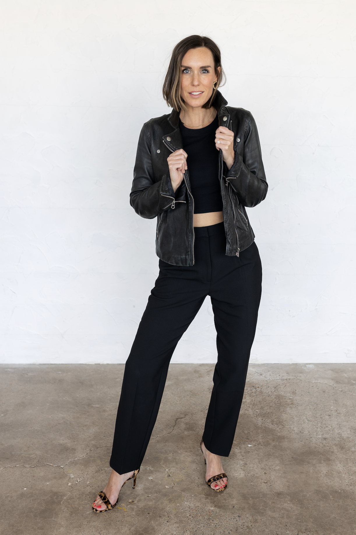 Anne Liebman, wearing black leather moto jacket, smiling